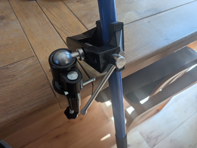 Desk vice, adjustable angle, holding a paint roller handle